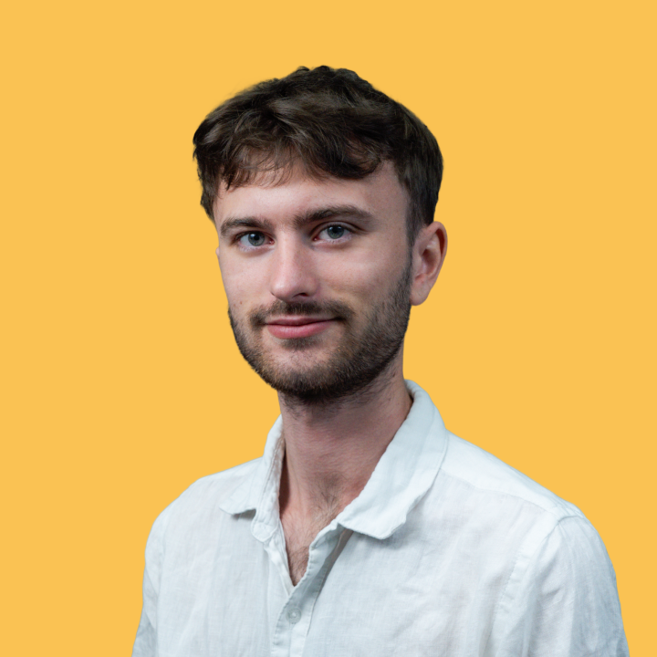 A headshot of Ethan David Lee on a yellow background.
