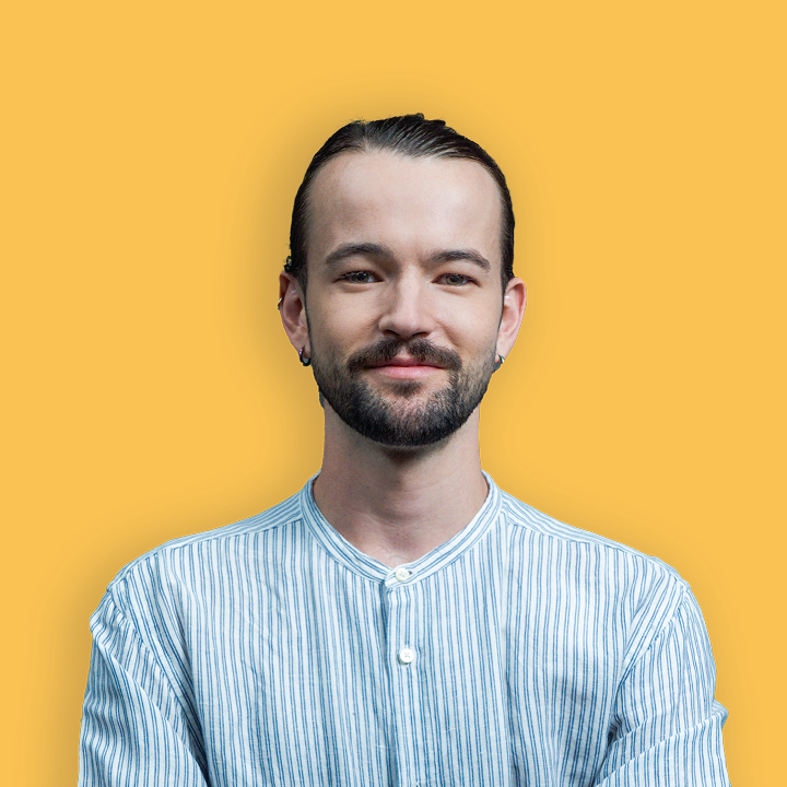 A headshot of Seb Morgan on a yellow background.