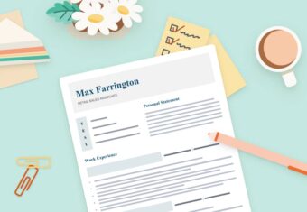 A CV on a green table surrounded by a pen, a coffee mug, and a plant, and various other supplies, demonstrating how to write a CV.