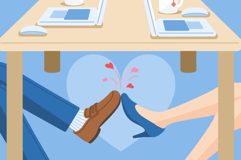 an image showing two pairs of feet touching in a romantic way under a work desk with laptops on it, representing an office romance.